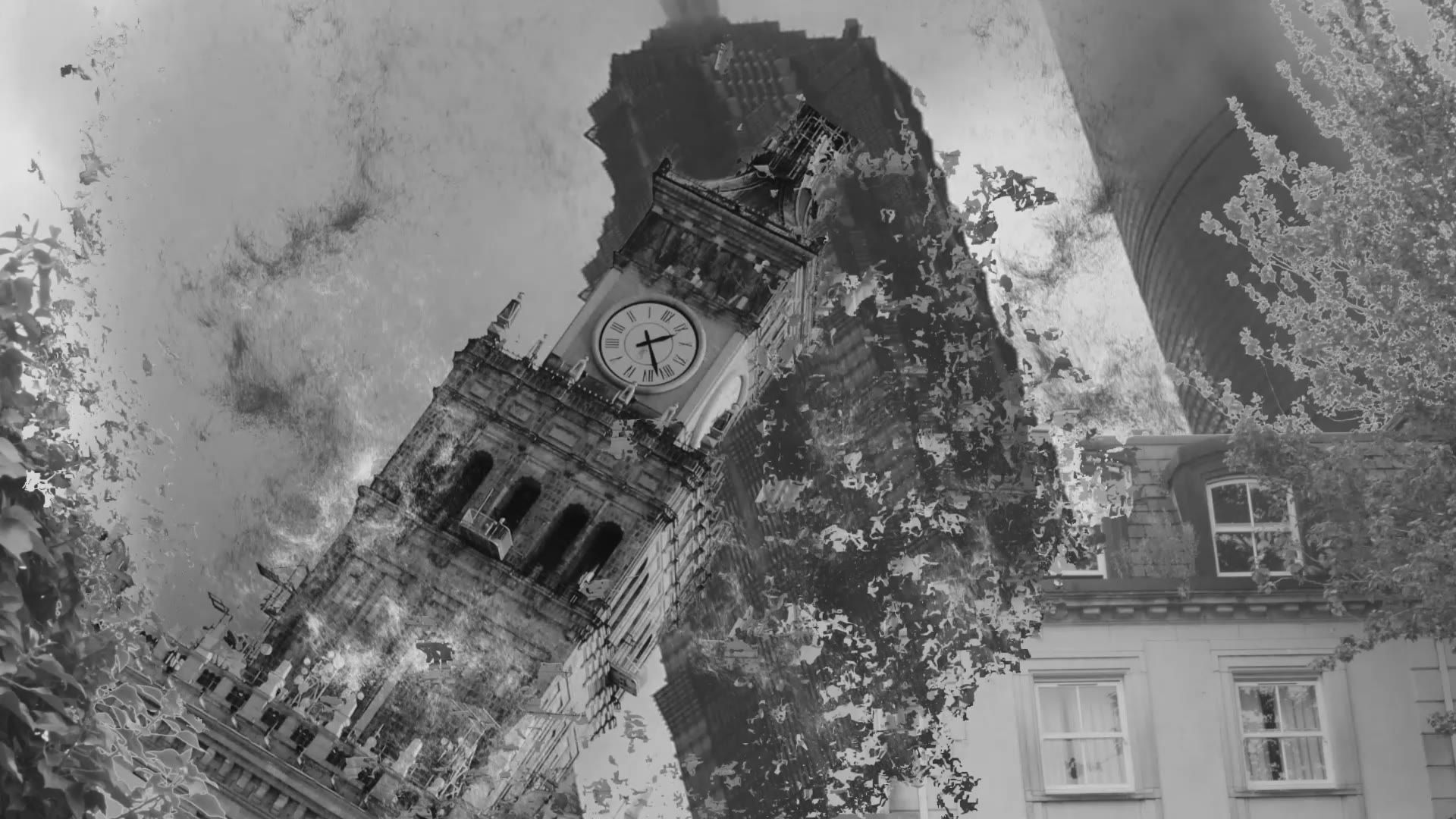 A clock tower tilting over a street in black and white, smoke filling the sky behind it.