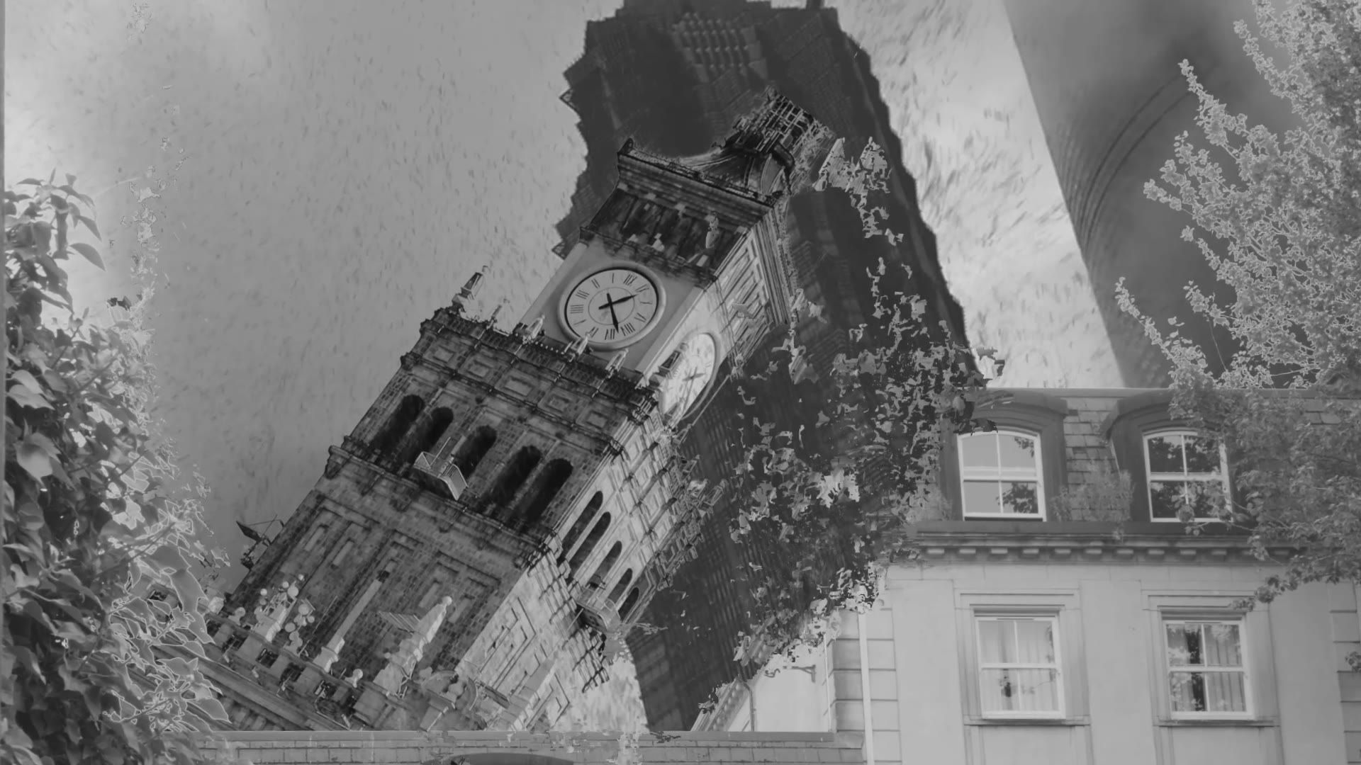 The clock tower rising behind the building at the start of the shot.