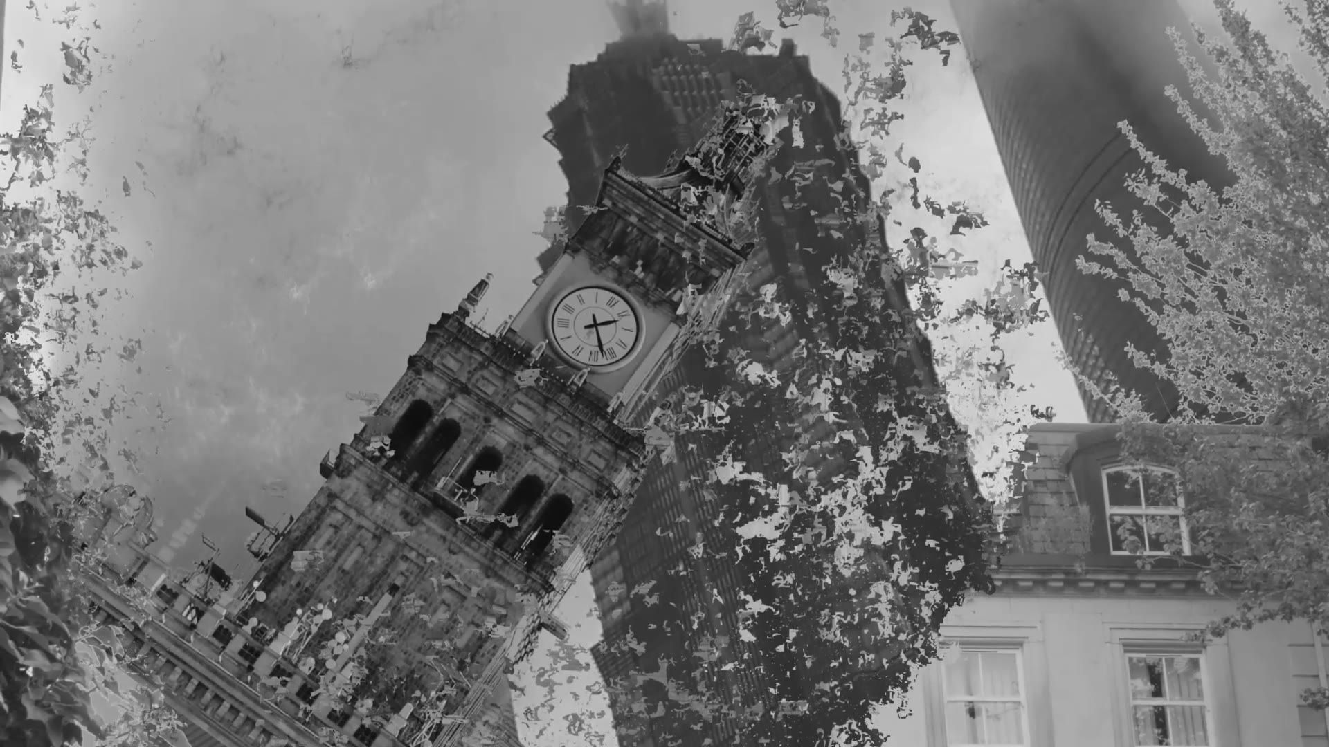 The tower leaning further as smoke spreads across the frame.
